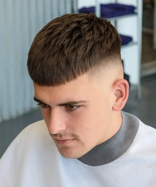 Caesar skin fade cut with cropped fringe and defined layered texture on top