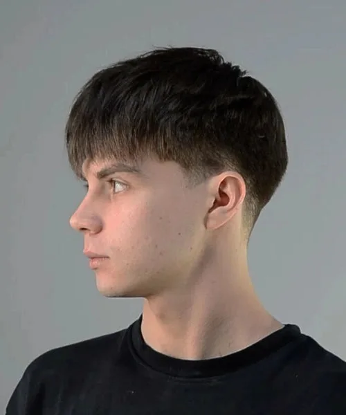 Caesar haircut with even sides, blunt fringe, and uniform textured top for a classic silhouette