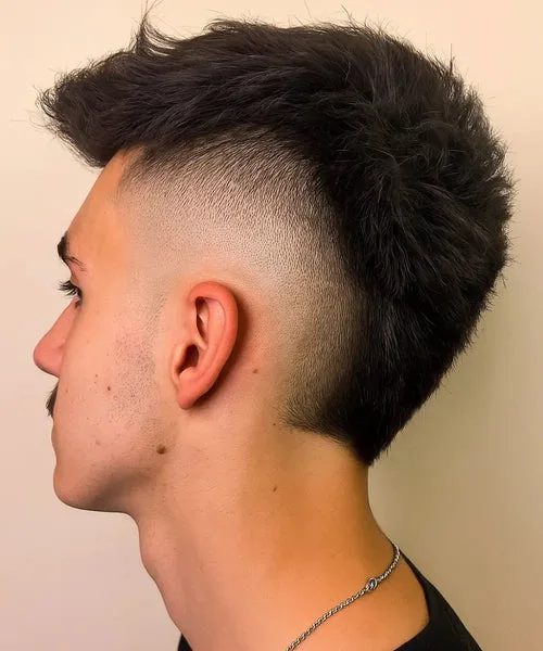 High burst fade haircut with curved taper around the ear and voluminous top style