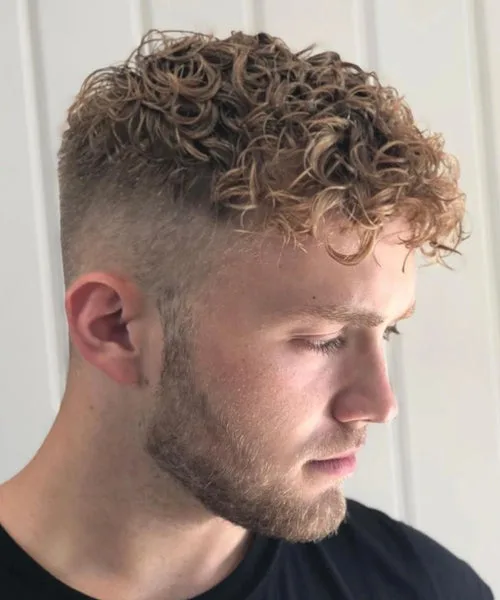 High fade haircut with curly top for textured volume and clean tapered sides