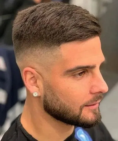 High fade short haircut with tight sides and textured short top for clean, bold look