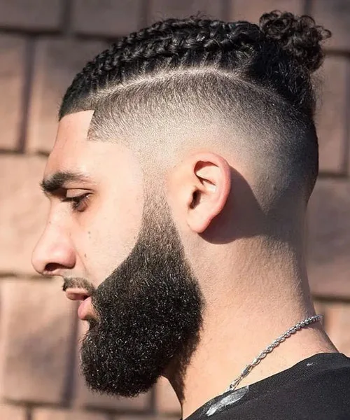 High fade haircut with braided top and sharp faded sides for bold, modern edge