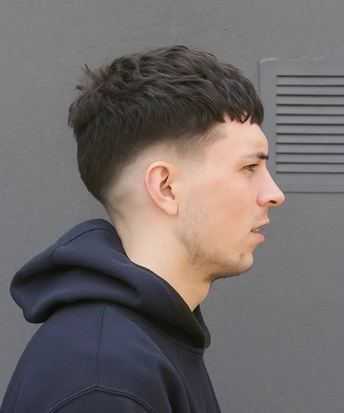 Low Caesar cut with cropped fringe, low fade sides, and textured top