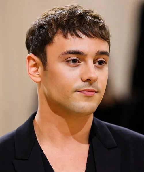 Soft Caesar cut with laid fringe, tapered sides, and feathered texture for a relaxed look