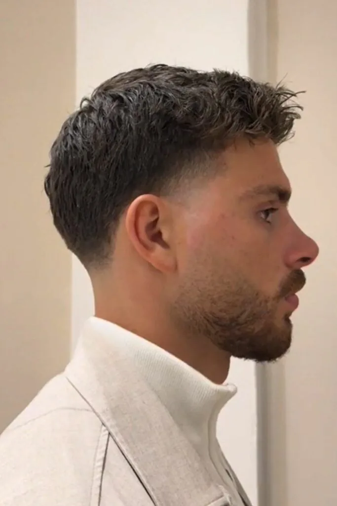 Classic low taper fade on straight hair with a neat short top and a clean low taper at the sides